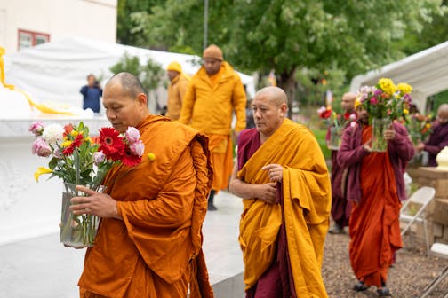 Visiting monks brought flowers to be placed on the Stupa Friday.