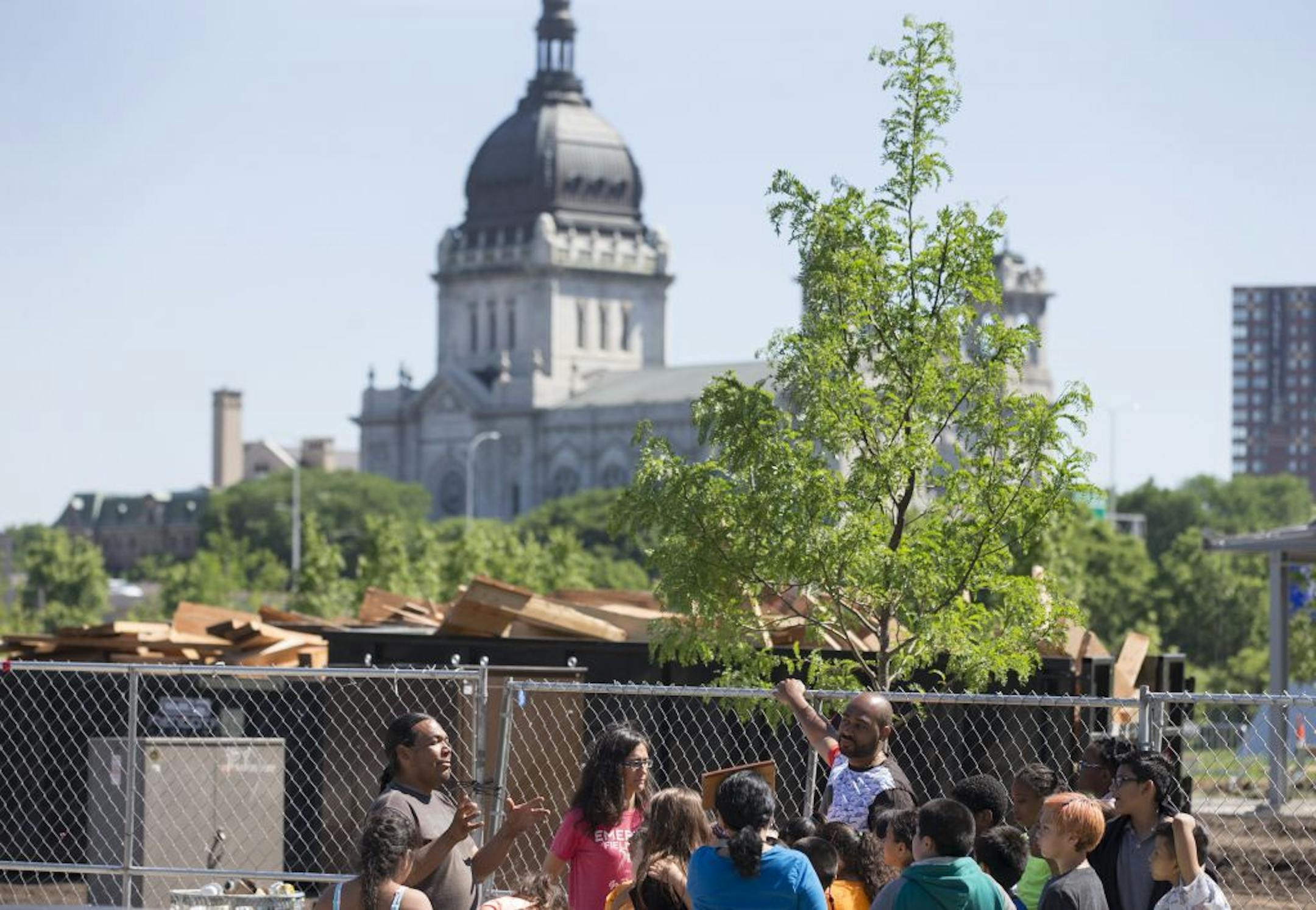 Sam Wounded Knee left, talked to fourth-grade students from Emerson Spanish Immersion school about why the "Scaffold" had to come down at the Walker Sculpture garden. The wood was placed in a dumpster after the sculpture was dismantled Monday in Minneapolis.