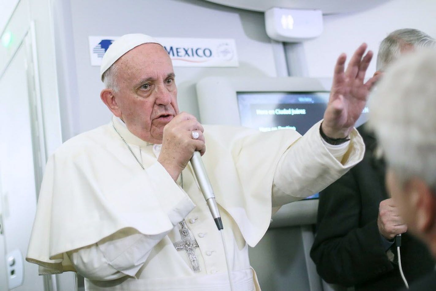 In this photo taken Wednesday, Feb. 17, 2016 Pope Francis meets with journalists aboard the plane during the flight from Ciudad Juarez, Mexico to Rome, Italy.