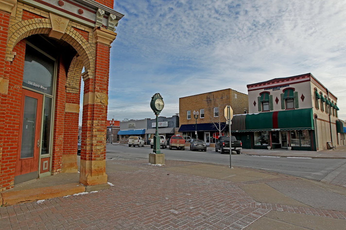 The Fletcher Building, right, with its green awnings and painted brick, sits on a prominent corner in downtown Farmington.