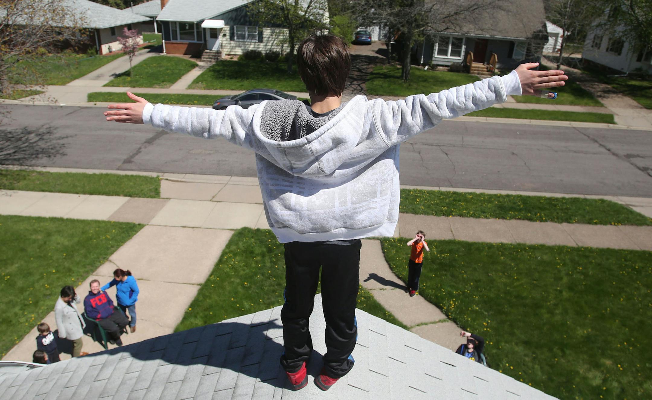 After climbing the roof of the familyís home and cleaning the gutters, Kieran seems to relish his man-like role in the household Thursday, April 29, 2016, in West St. Paul, MN. ìIím the King of the world!î Kieran shouts, arms outstretched, recreating a famous scene with Leonardo Di Caprio from the movie ìTitanic'. Down below, his parents, friends and neighbors gathered to chat, gazed up at Kieran in amusement.](DAVID JOLES/STARTRIBUNE)djoles@startribune Each day, an esti