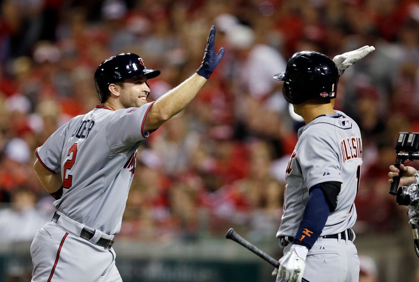 American League's Brian Dozier, of the Minnesota Twins, is congratulated after hitting a home run during the eighth inning of the MLB All-Star baseball game, Tuesday, July 14, 2015, in Cincinnati.