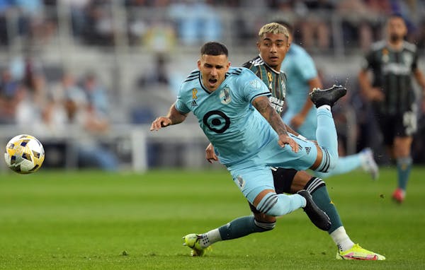 Minnesota United midfielder Franco Fragapane (7) went flying as Los Angeles Galaxy defender Julian Araujo (2) stuck his foot out to defend in the firs