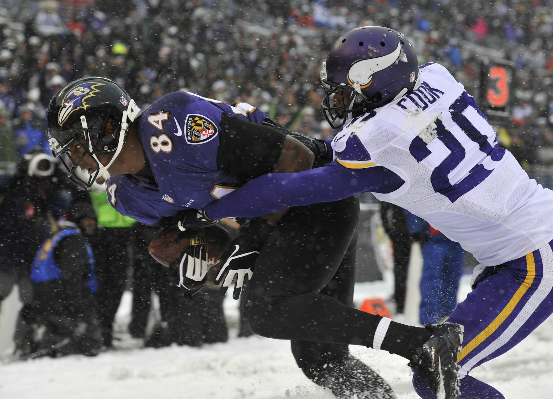 Baltimore Ravens tight end Ed Dickson, left, scores a touchdown in front of Minnesota Vikings cornerback Chris Cook in the first half of an NFL football game, Sunday, Dec. 8, 2013, in Baltimore.