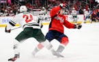 Wild defenseman Matt Dumba and Capitals right winger Nicolas Aube-Kubel battled for the puck during Tuesday’s game.