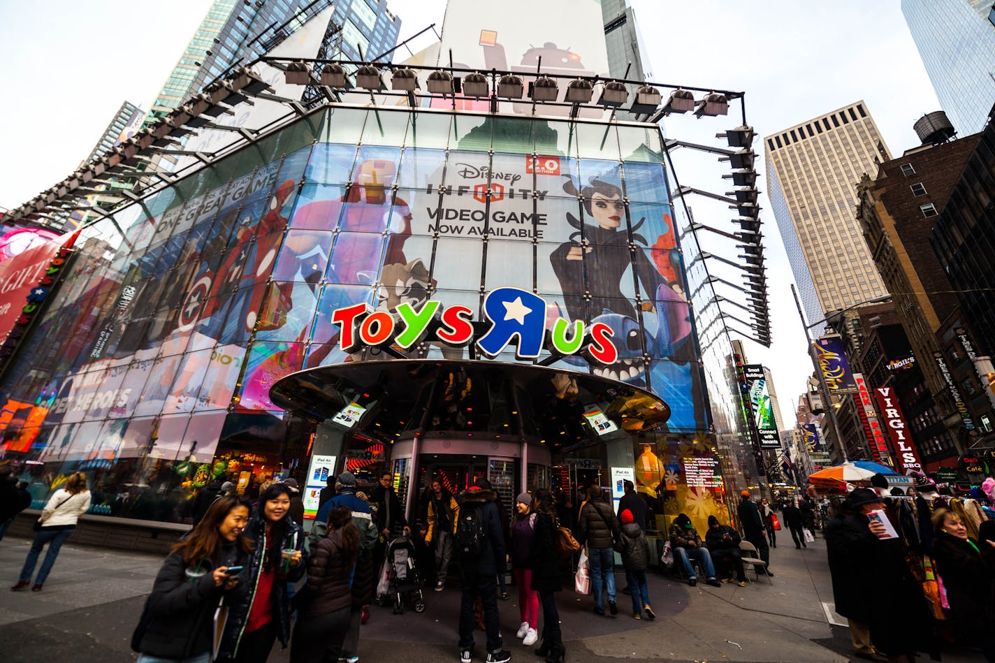 New York City, NY, USA - December 4, 2014: View of Times Square, NYC. Pedestrians and tourists on street outside Toys R US.