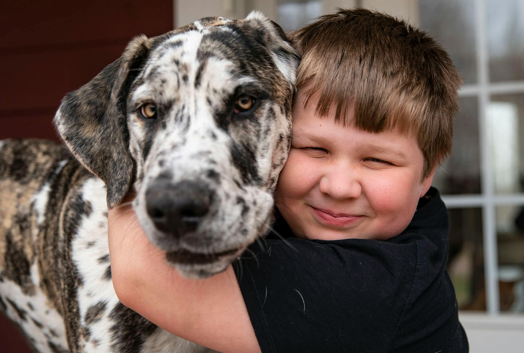 Leo Sather, 8, played with his captain underpants toys on his front porch in Cloquet. Leo has autism and it's difficult for him to fully grasp the concept of the pandemic but he finds joy through his toys and his puppy, Una.