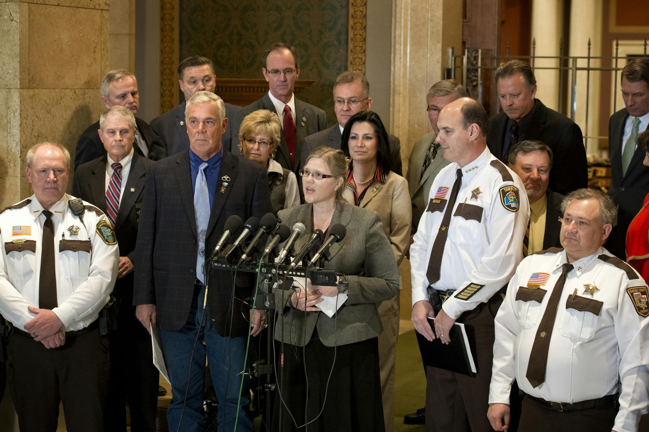 A bipartisan group of lawmakers and members of the Minnesota Sheriff's Association stood in front of the House chambers to introduce an alternative gun bill that doesn't include background checks. The bill's author is Rep. Debra Hilstrom, center and is supported by Sen Tony Cornish, left, a gun rights advocate and Hennepin County Sheriff Rich Stanek. On right is Carver County Sheriff J.A. Olson.