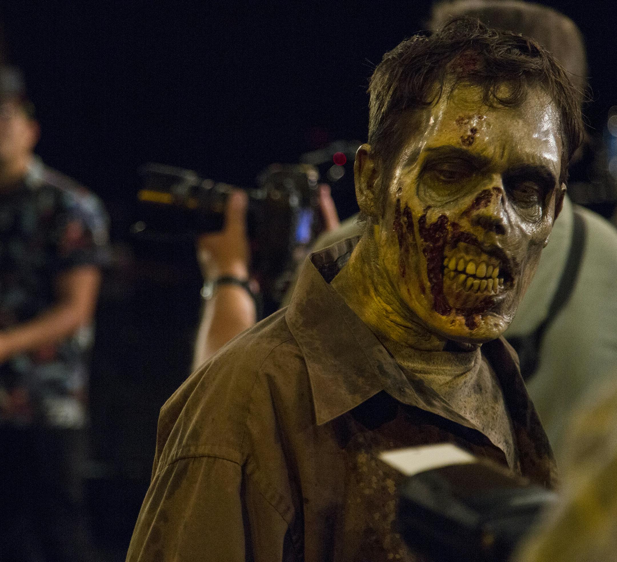 A zombie walks around and interacts with the media during a zombie bootcamp led by Greg Nicotero, co-executive producer and director of "The Walking Dead," at the Globe Theater at Universal Studios on Wednesday, June 8, 2016. (Dillon Deaton/Los Angeles Times/TNS)
