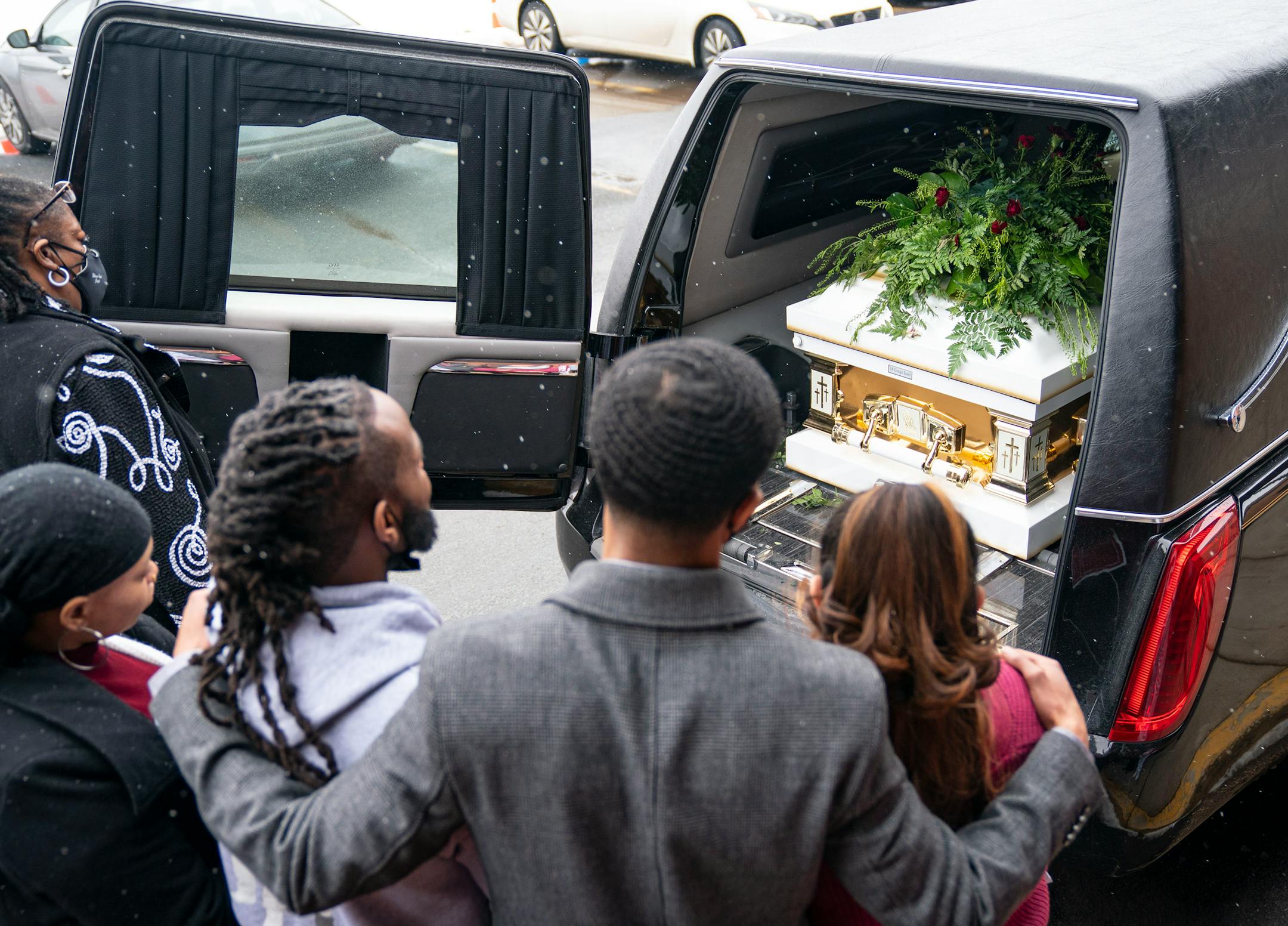 Loved ones of Jahmari Rice take one final look at his casket inside the hearse after his funeral Wednesday.