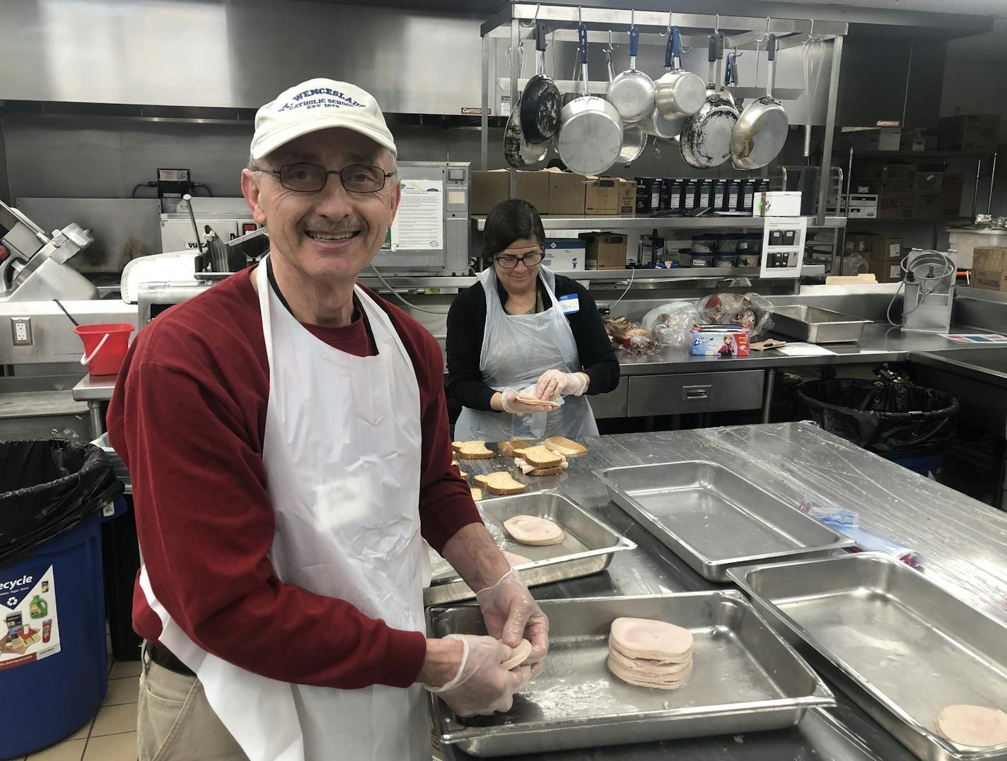 Catholic Charities volunteers Norb Sticha, a retired electrician, and Susie Van Hoomissen, who is furloughed from St. David's Center for Child and Family Development, help prepare thousands of meals weekly, is the face of stepped-up efforts by funders to provide food, child care and other services in the face of unprecedented demand for assistance amid the COVID-19 instant recession. Photo: Neal.St.Anthony@startribune.com