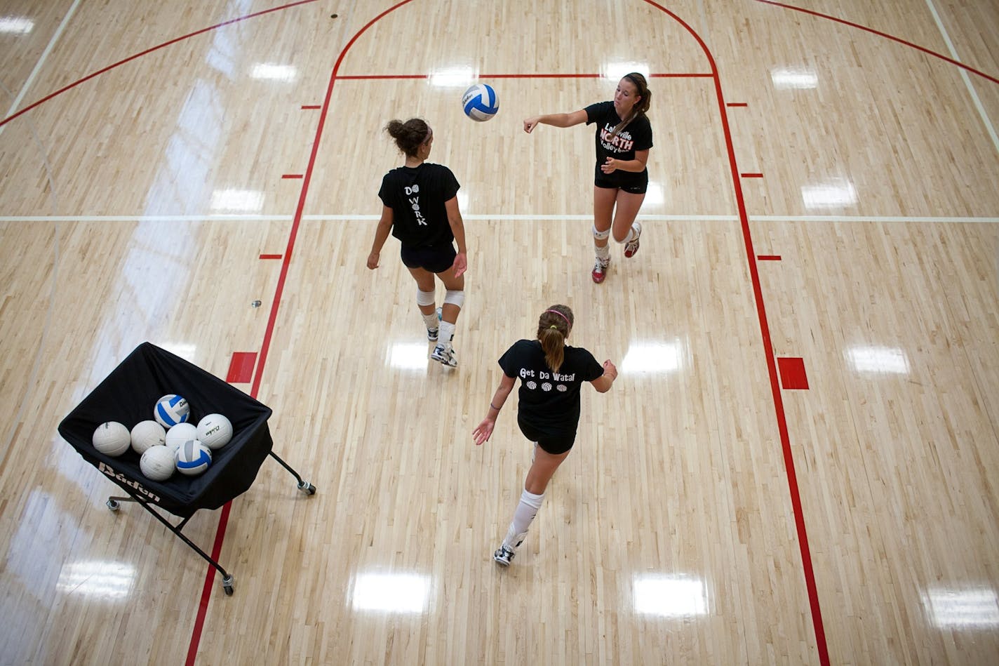 Lakeville North volleyball players practiced serving Monday, August 15, 2011.