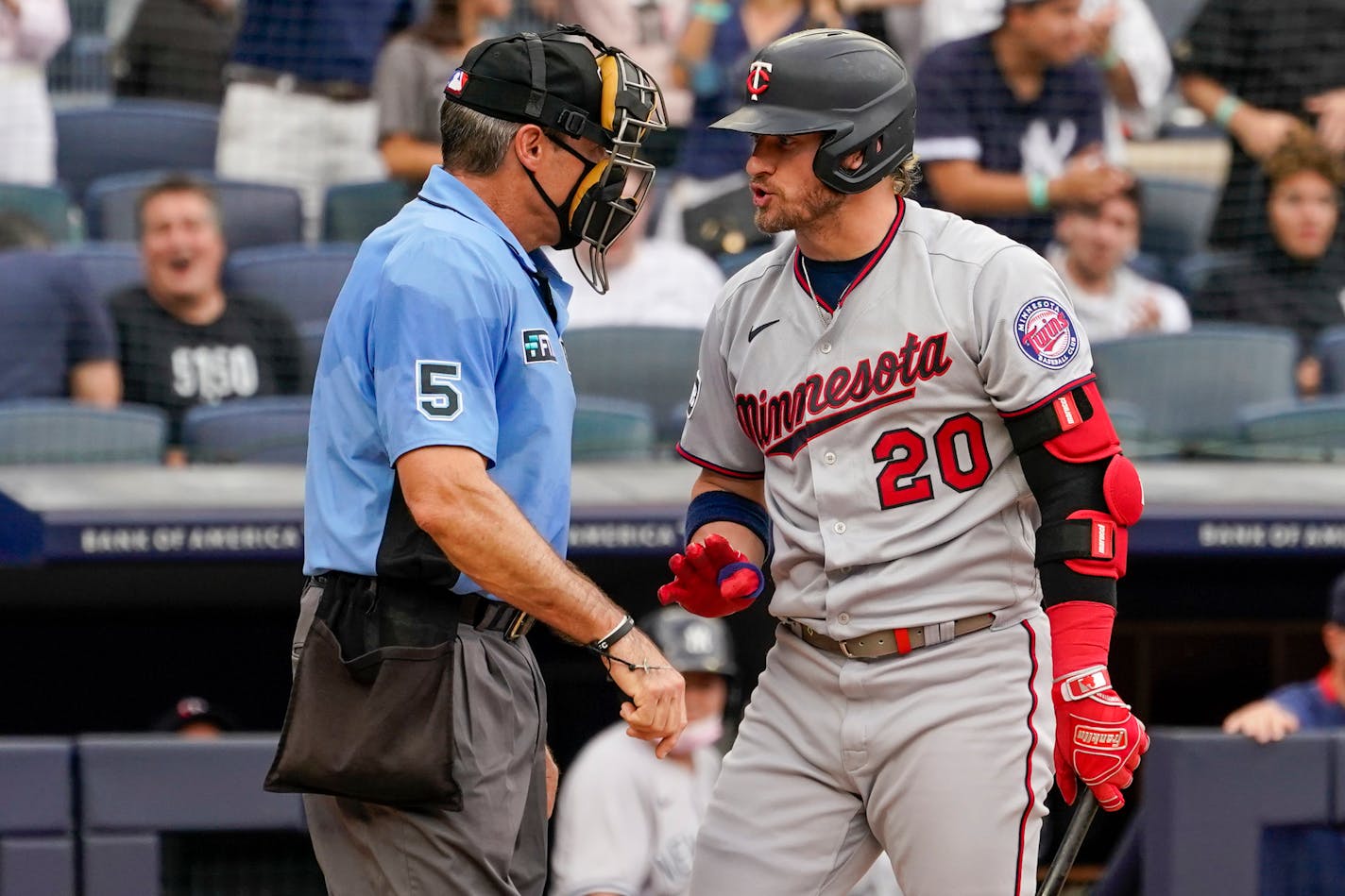 Minnesota Twins' Josh Donaldson (20) argues with umpire Angel Hernandez (5) after striking out in the fifth inning of a baseball game against the New York Yankees, Saturday, Aug. 21, 2021, in New York. (AP Photo/Mary Altaffer)