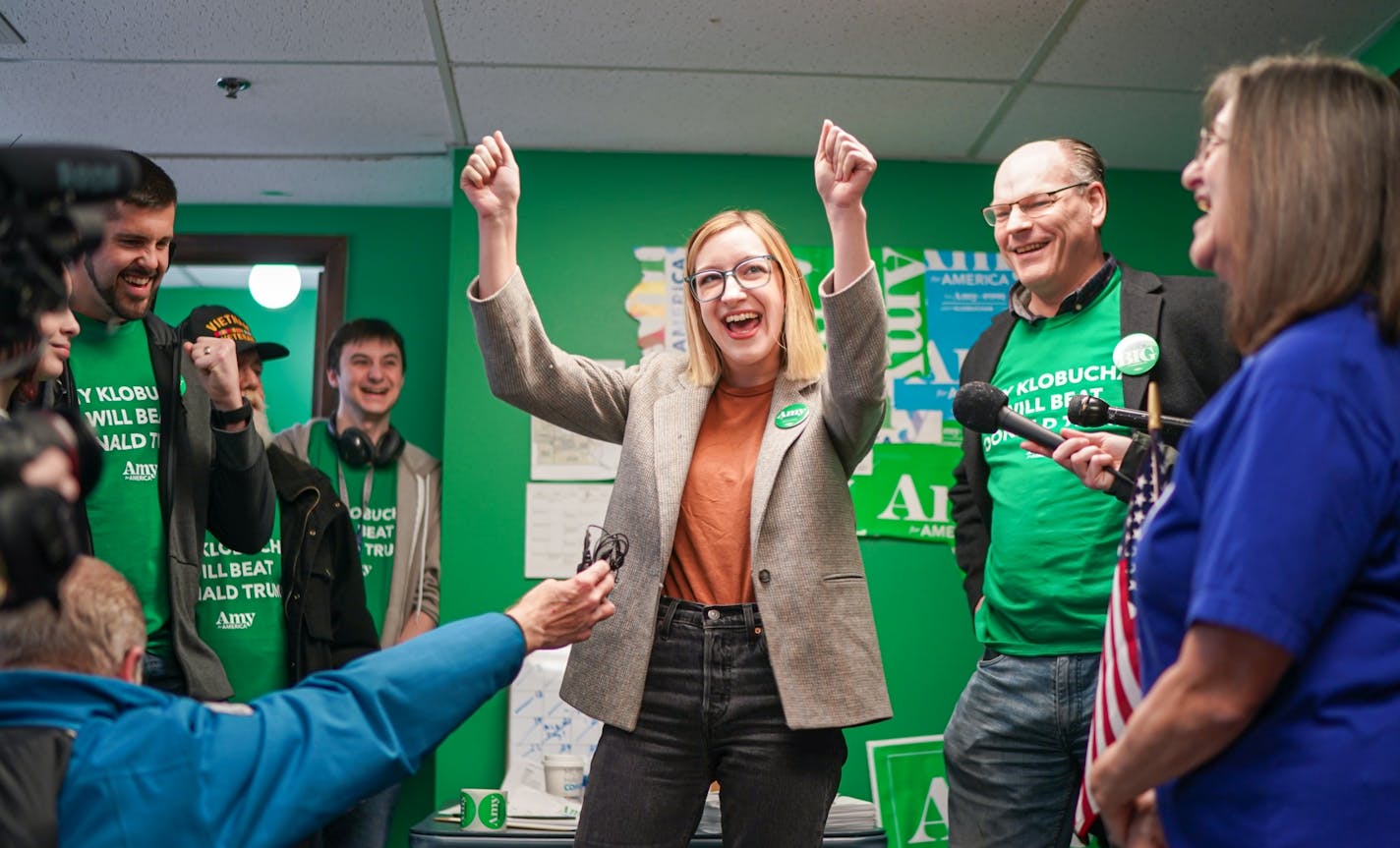 In advance of tonight's caucuses, John and Abigail Bessler, Sen. Amy Klobuchar's husband and daughter, center and second from right, visited the Amy for America Des Moines field office to kick off canvass launches around Iowa.