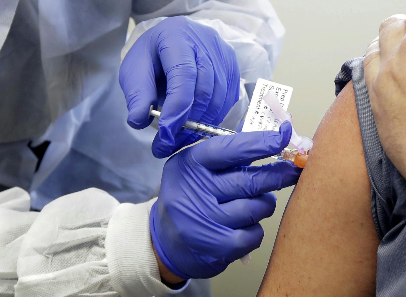 FILE - In this March 16, 2020, file photo, Neal Browning receives a shot in the first-stage safety study clinical trial of a potential vaccine for COVID-19.