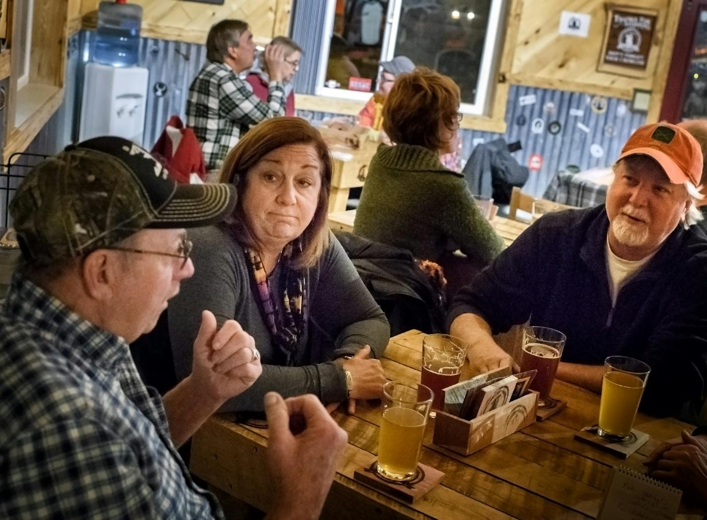 Bob Jenkins, at left, Cindy Geary and Mick Geary talked about Sen. Al Franken at their table at the Moose Lake Brewing Co. "I hope he survives," Cindy Geary said.