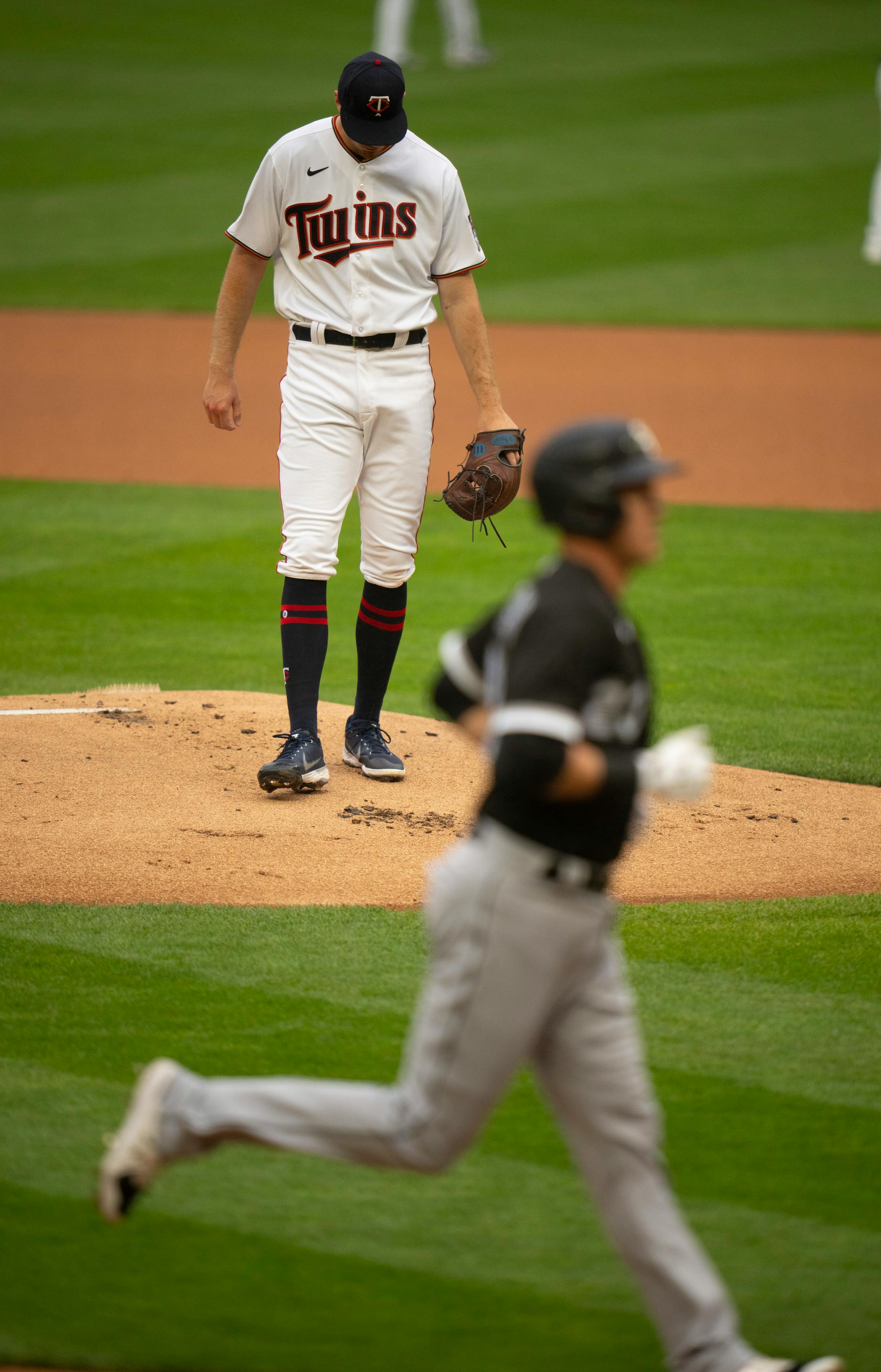 Minnesota Twins starting pitcher Bailey Ober on the mound while Chicago White Sox left field Jake Lamb (23) headed home after a first inning solo home run. Ober was making his major league debut Tuesday night.