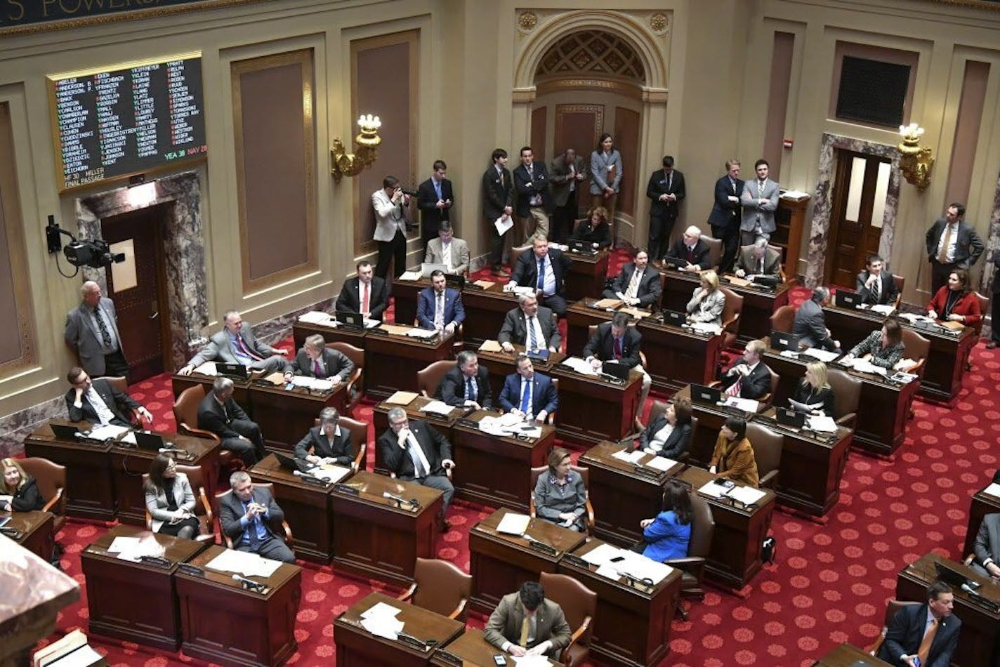 Senators work on the floor Monday Feb. 27, 2017 in St. Paul, Minn. The Minnesota Legislature has voted to repeal the state's long-standing ban on Sunday liquor sales. The state Senate passed a bill undoing the Prohibition-era ban on a 38-28 vote Monday.