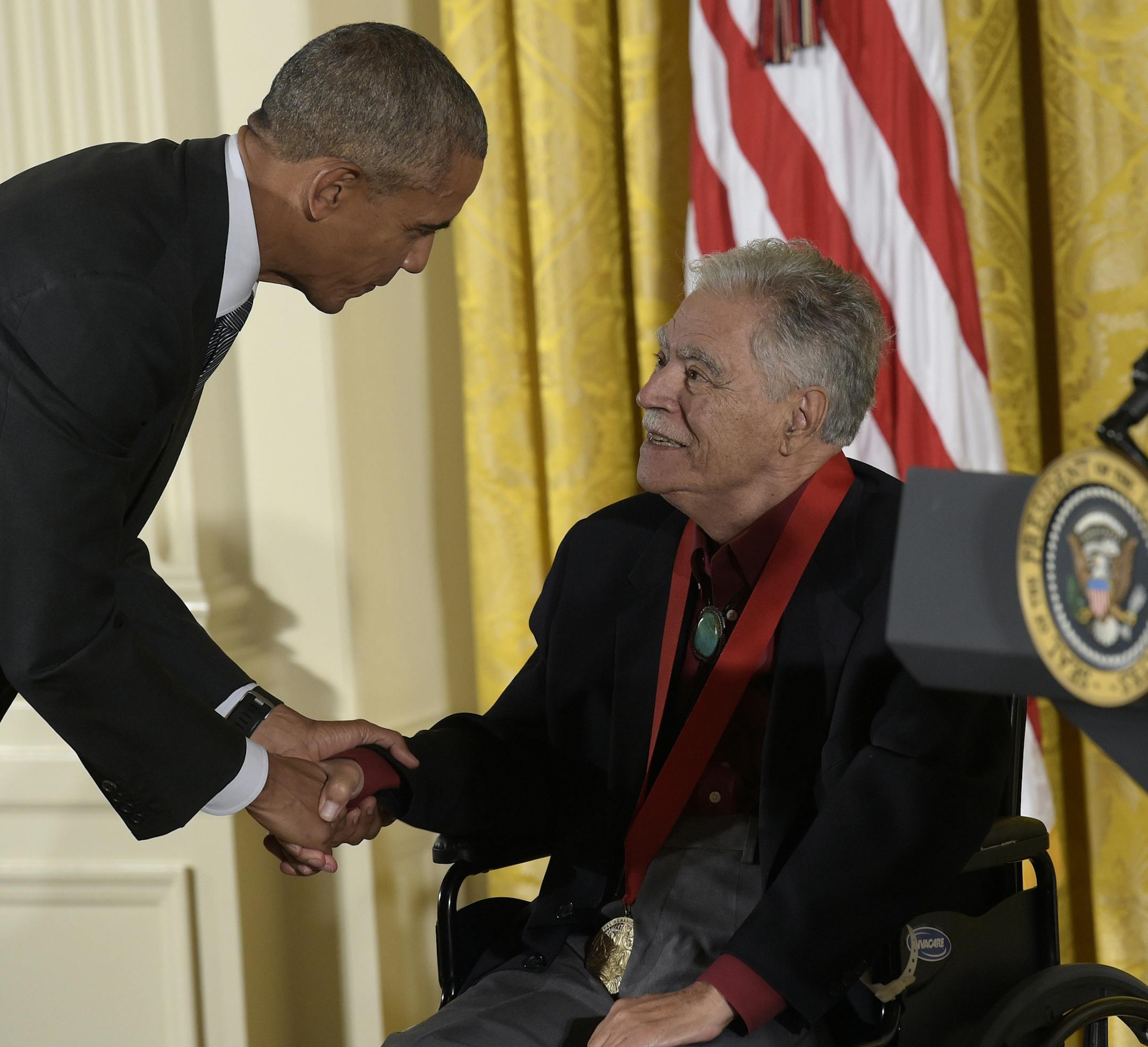 FILE - In this Sept. 22, 2016, file photo, President Barack Obama shakes hands with author, Rudolfo Anaya, after presenting him with the 2015 National Humanities Medal during a ceremony in the East Room of the White House in Washington. Anaya, 82, who helped launch the 1970s Chicano Literature Movement with his novel "Bless Me, Ultima," died Sunday, June 28, 2020. (AP Photo/Susan Walsh, File)
