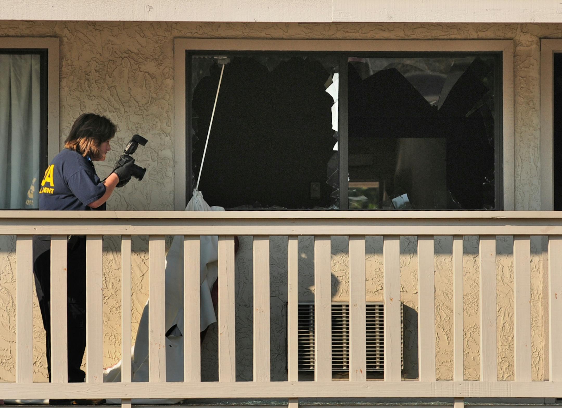A standoff with police involving numerous hostages at a Red Roof Inn near Interstate 494 and Valley Creek Road early Friday left one man shot to death by police and another under arrest, authorities said. BCA agent photographed the scene at the Red Roof Inn.