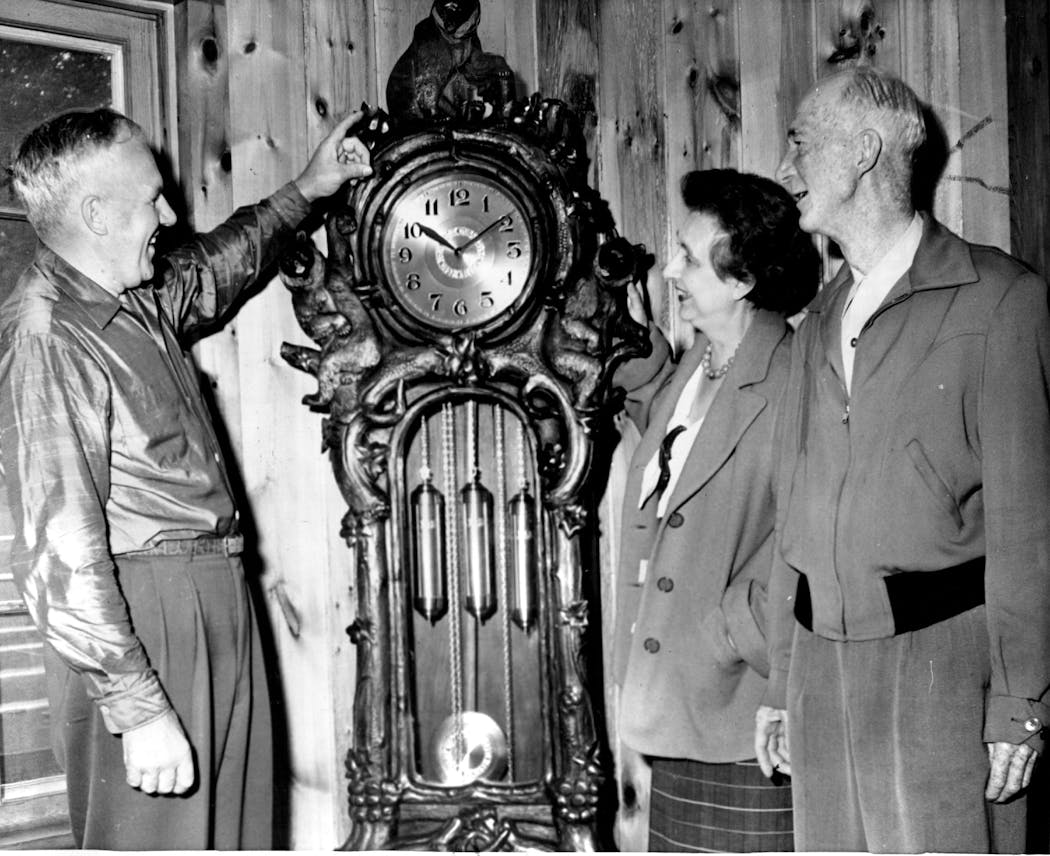 George Nelson, Sr. points out a bear on his grandfather type clock which he brought from Switzerland on Aug. 30, 1956.