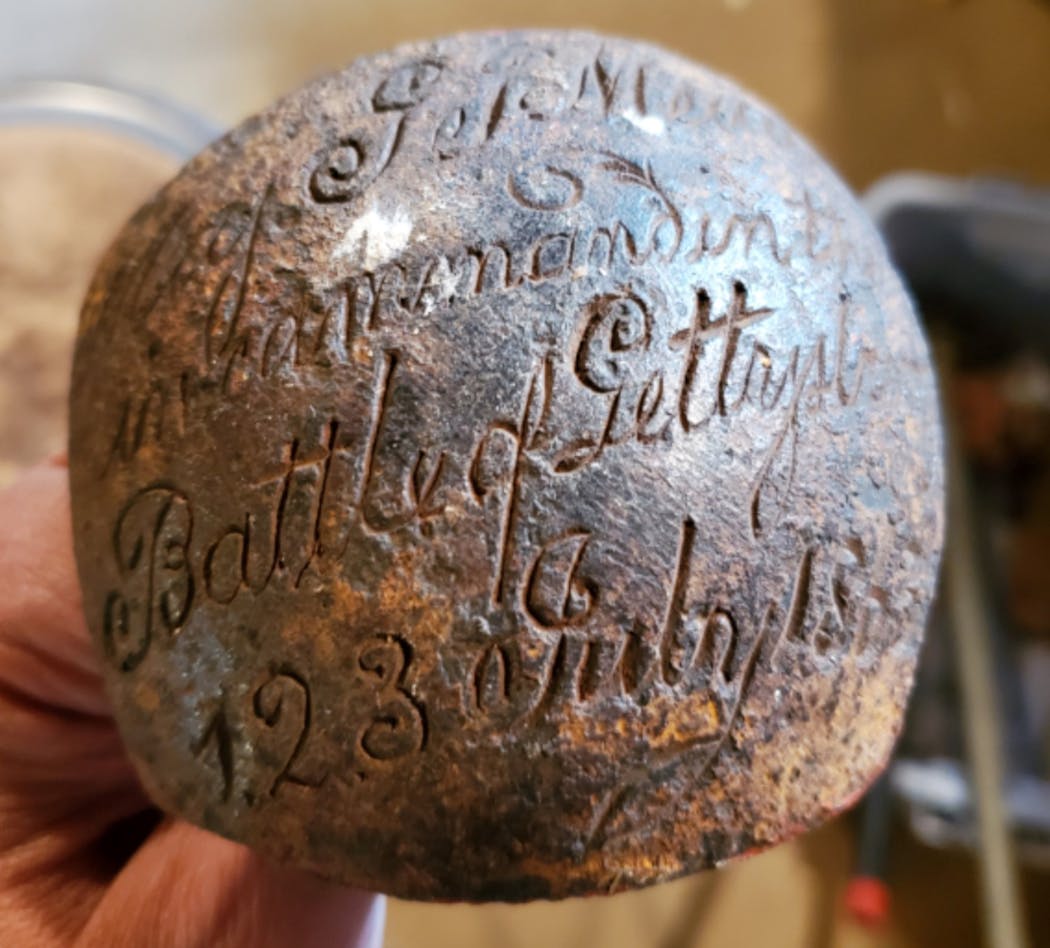 This cannonball is just a fragment, but the engraving is critical to its importance.