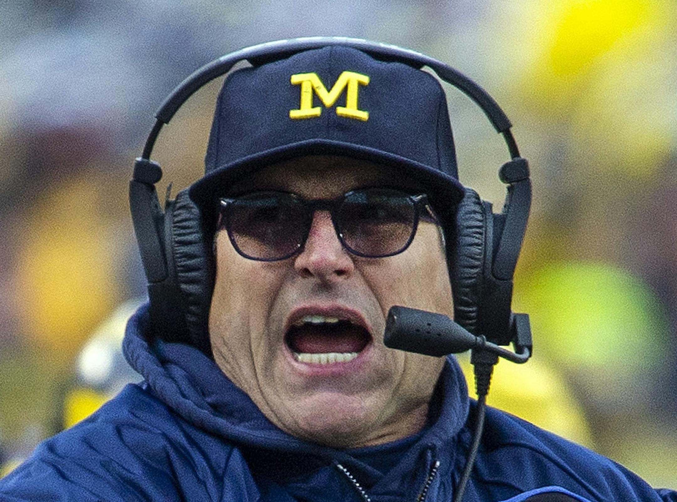 Michigan head coach Jim Harbaugh calls a timeout in the third quarter of an NCAA college football game against Ohio State in Ann Arbor, Mich., Saturday, Nov. 30, 2019. Ohio State won 56-27. (AP Photo/Tony Ding) ORG XMIT: MITD122