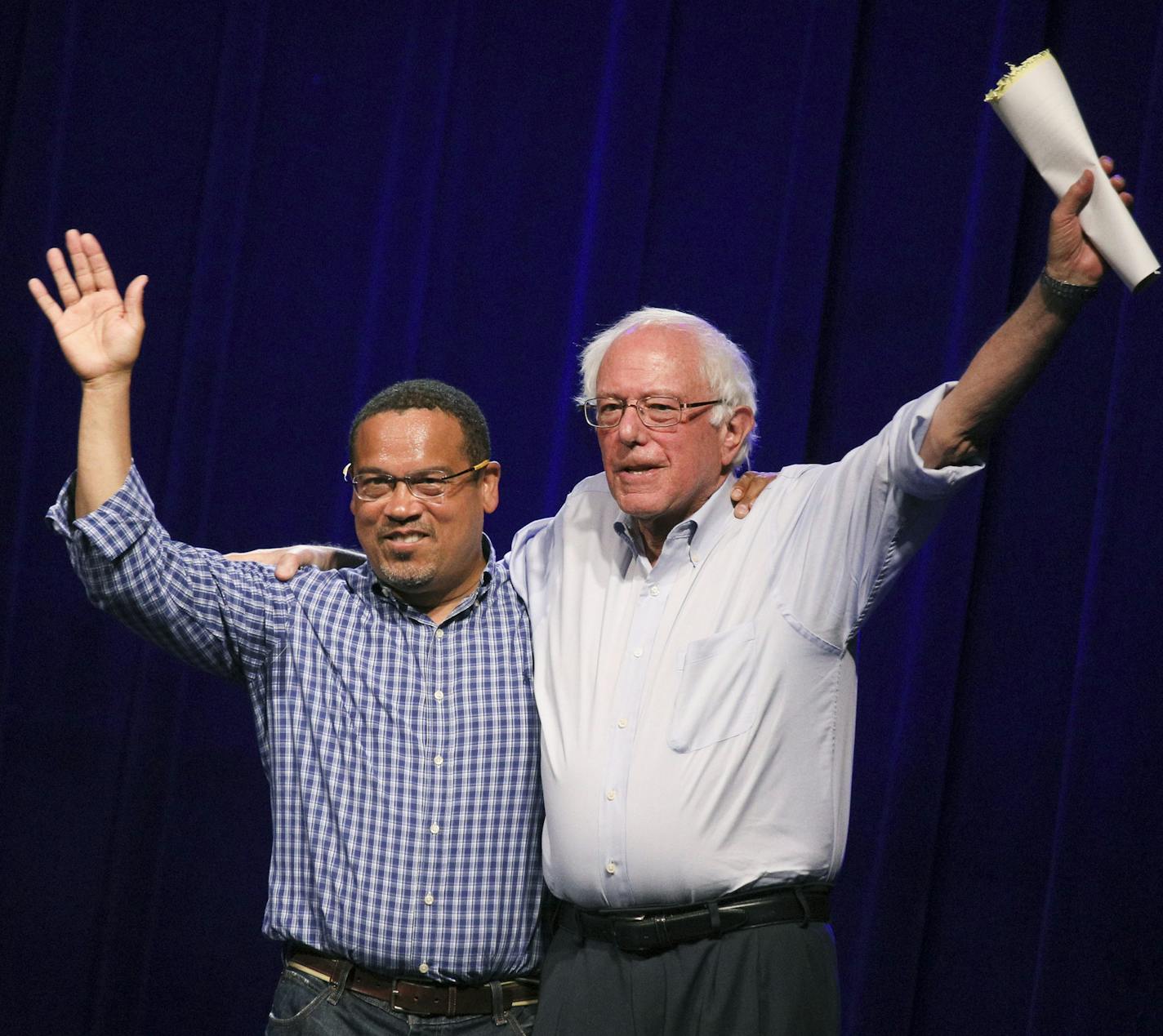 Minnesota Rep. Keith Ellison, left, waves to the audience with Sen. Bernie Sanders, right, at a rally to give support for his attorney general bid at First Avenue Friday, July 13, 2018, in Minneapolis. Sanders is backing Rep. Keith Ellison's bid for Minnesota Attorney General. Sanders visited Minnesota on Friday to headline a pair of rallies for Ellison's campaign.