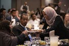 U.S. Rep. Ilhan Omar offered a plate of dates to others at her table as iftar commenced. At center is her father, Nur Omar Mohamed.