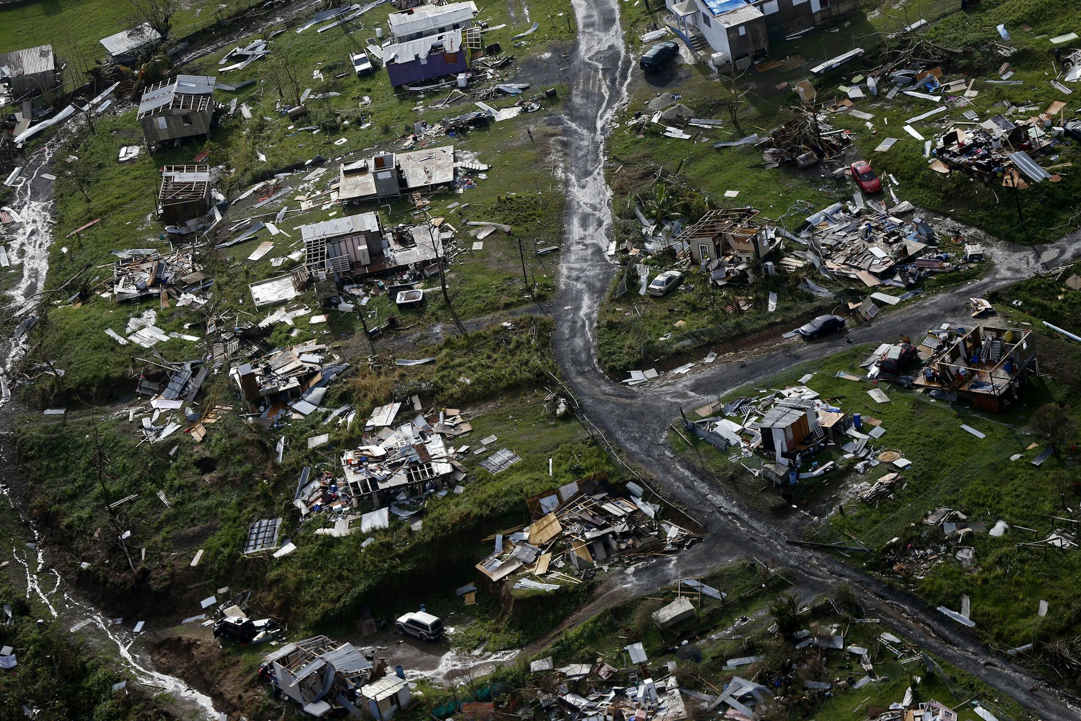 FILE - In this Thursday, Sept. 28, 2017 file photo, destroyed communities are seen in the aftermath of Hurricane Maria in Toa Alta, Puerto Rico. The House is on track to backing President Donald Trump's request for billions more in disaster aid, $16 billion to pay flood insurance claims and emergency funding to help the cash-strapped government of Puerto Rico stay afloat. The hurricane aid package Thursday, Oct. 12, 2017, totals $36.5 billion and sticks close to a White House request, ignoring -