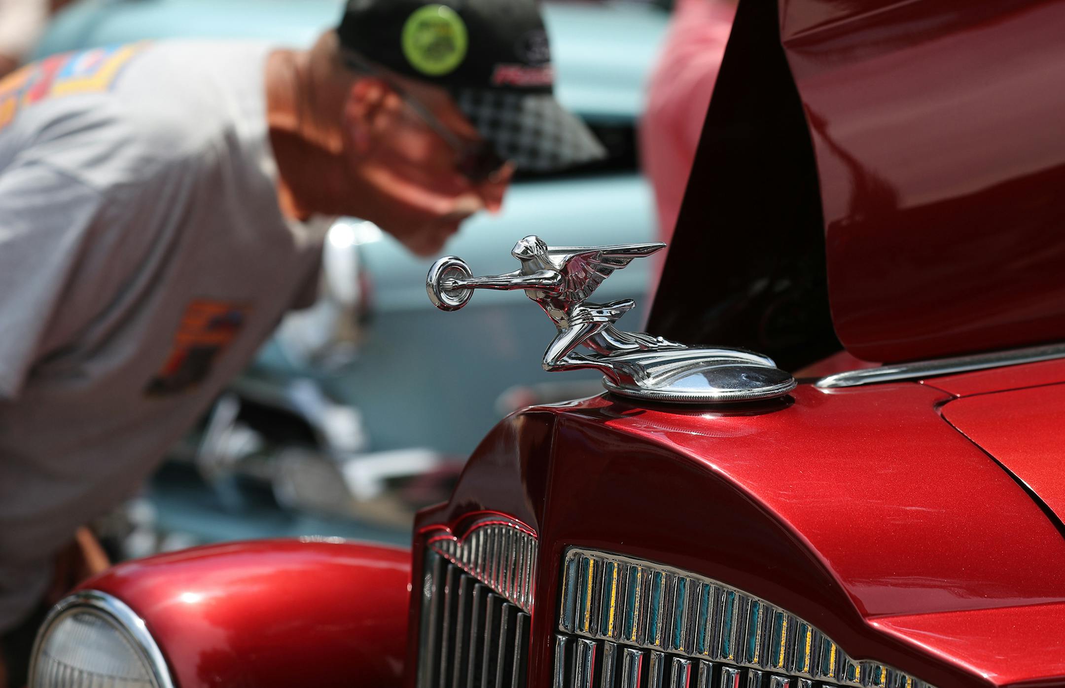 A Packard hood ornament and accompanying vintage luxury vehicle draws the attention of a passerby at the Minnesota Street Rod's Back to the Fifties weekend on Friday at the State Fairgrounds in St. Paul.