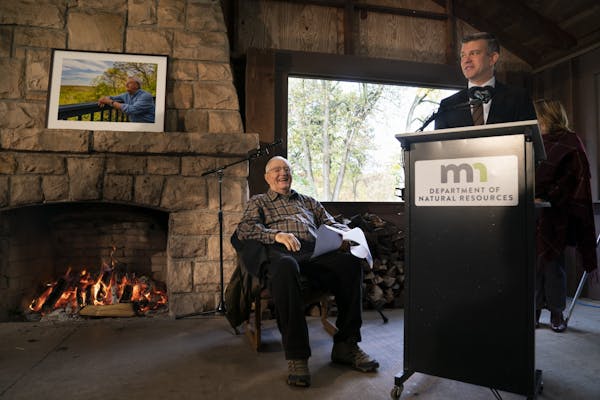 Vice President Walter Mondale sat in chair by a fireplace in a shelter as Rep. Ryan Winkler spoke about him at a dedication for part of William O'Brie