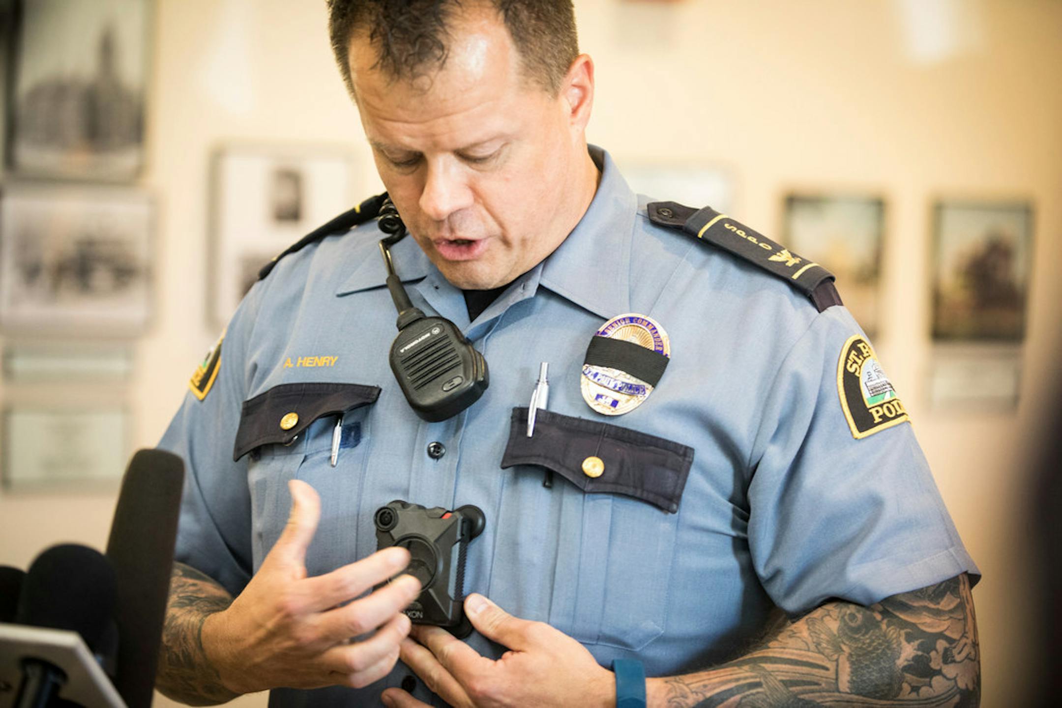 St. Paul police senior Cmdr. Axel Henry demonstrated how to turn on the new body cameras Tuesday.