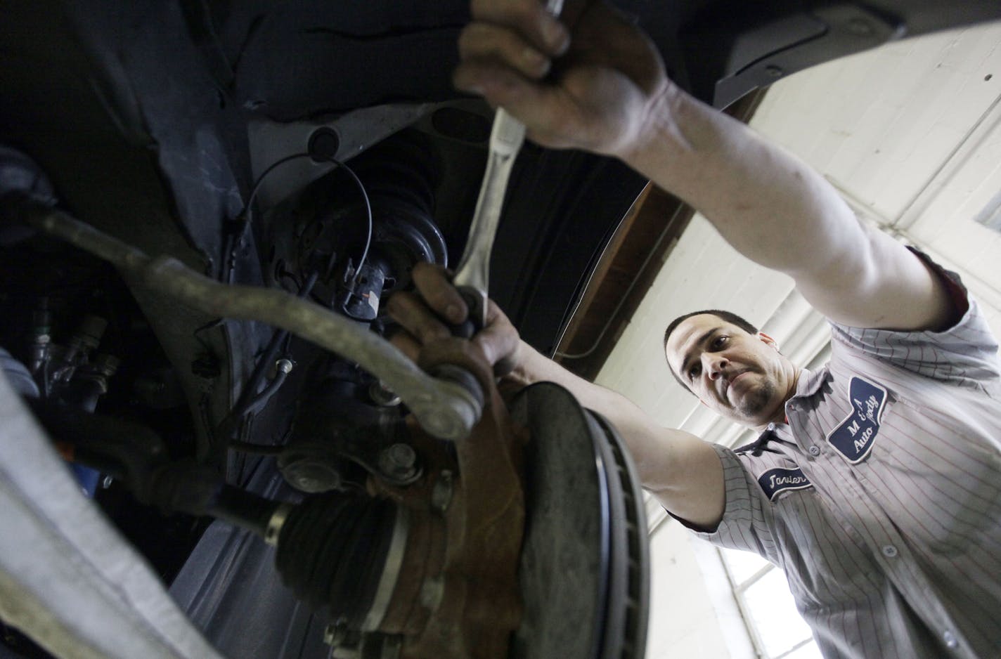 In this March 2, 2012 photo, Javier Soto works on a brake assembly at M&A Auto Body shop in Chicago. U.S. service companies expanded in February at the fastest pace in a year, as new orders rose and employment increased. (AP Photo/Nam Y. Huh) ORG XMIT: ILNH201