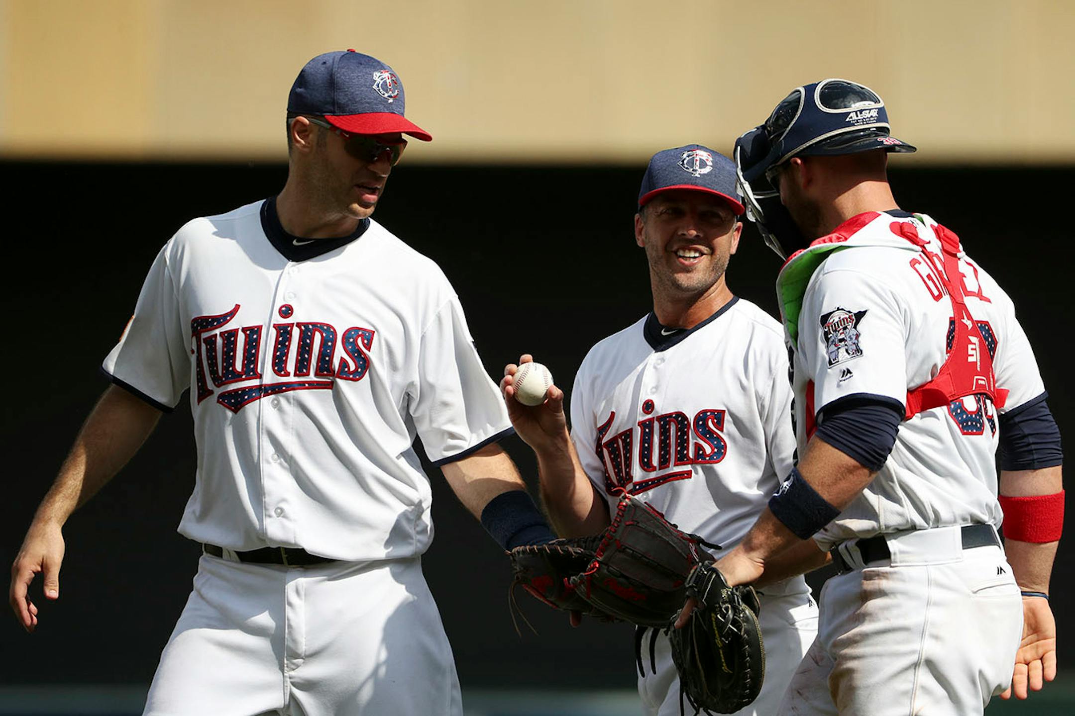 Minnesota Twins relief pitcher Brandon Kintzler (27) celebrated the win with Minnesota Twins catcher Chris Gimenez (38) and Minnesota Twins first baseman Joe Mauer (7).