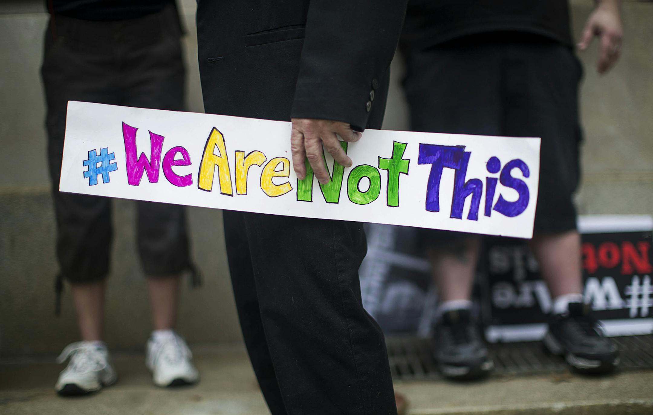 An opponent of a new state law that restricts transgender bathroom use and pre-empts local governments from creating their own anti-discrimination policies at a counter-rally, across the street from a rally for proponents of the new law, outside the the North Carolina State Capitol in Raleigh, April 11, 2016. (Ray Whitehouse/The New York Times)