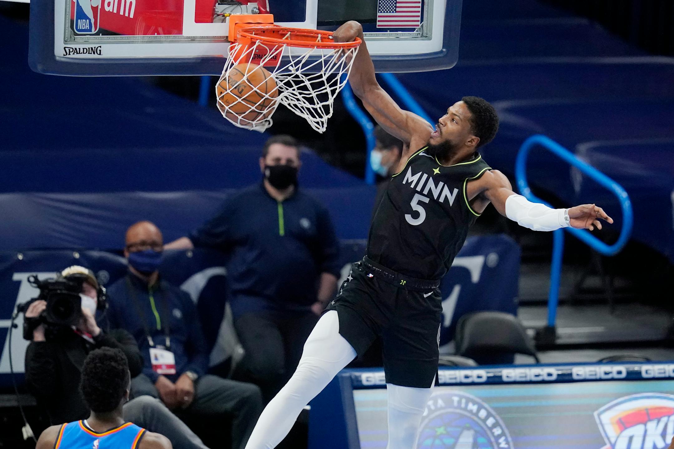 Minnesota Timberwolves guard Malik Beasley (5) dunks in front of Oklahoma City Thunder guard Hamidou Diallo, left, in the first half of an NBA basketball game Friday, Feb. 5, 2021, in Oklahoma City. (AP Photo/Sue Ogrocki)