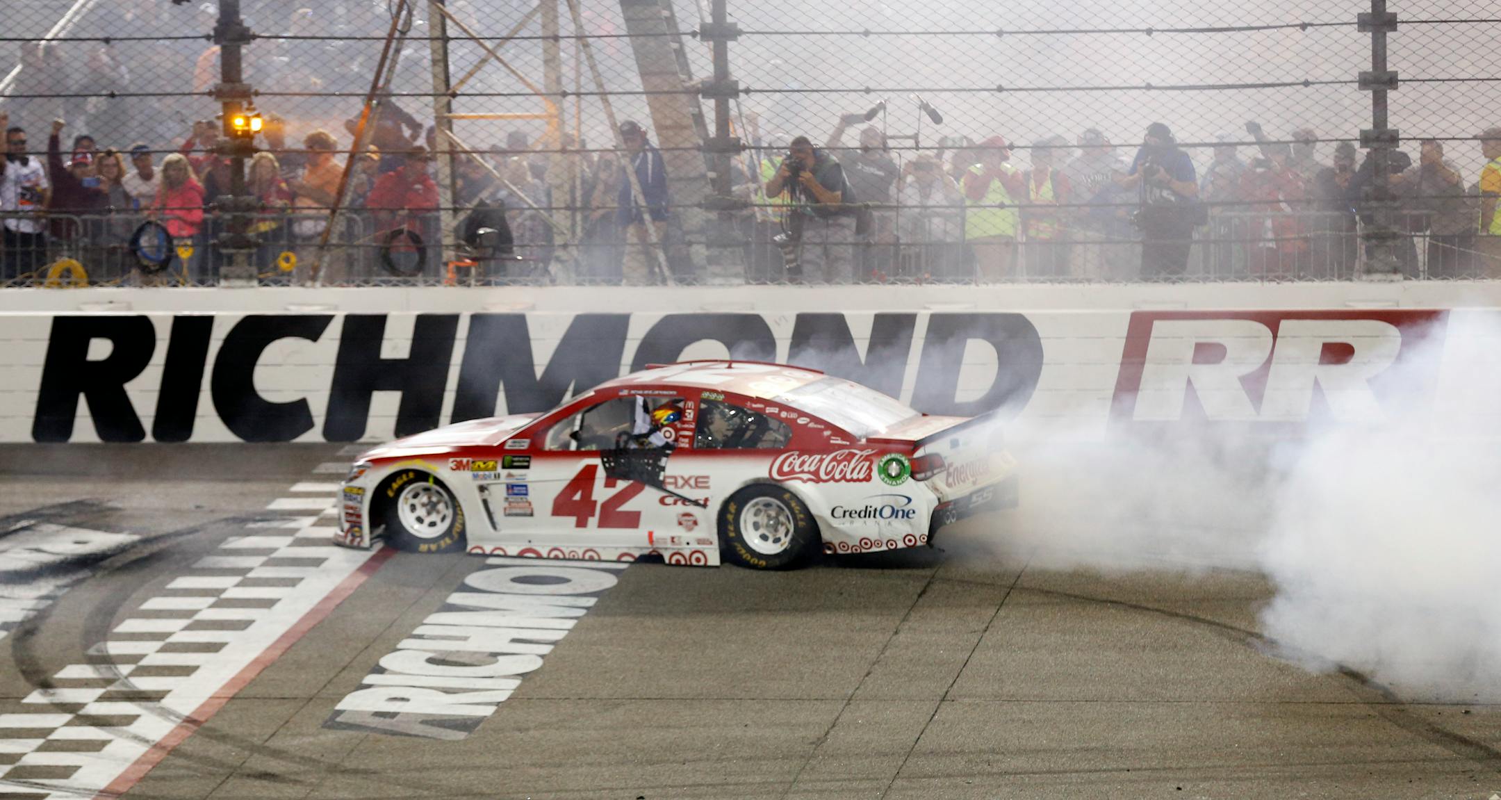 Kyle Larson does a burnout as he celebrates winning the NASCAR Cup Series auto race at Richmond International Raceway in Richmond, Va., Saturday, Sept. 9, 2017. (AP Photo/Steve Helber)