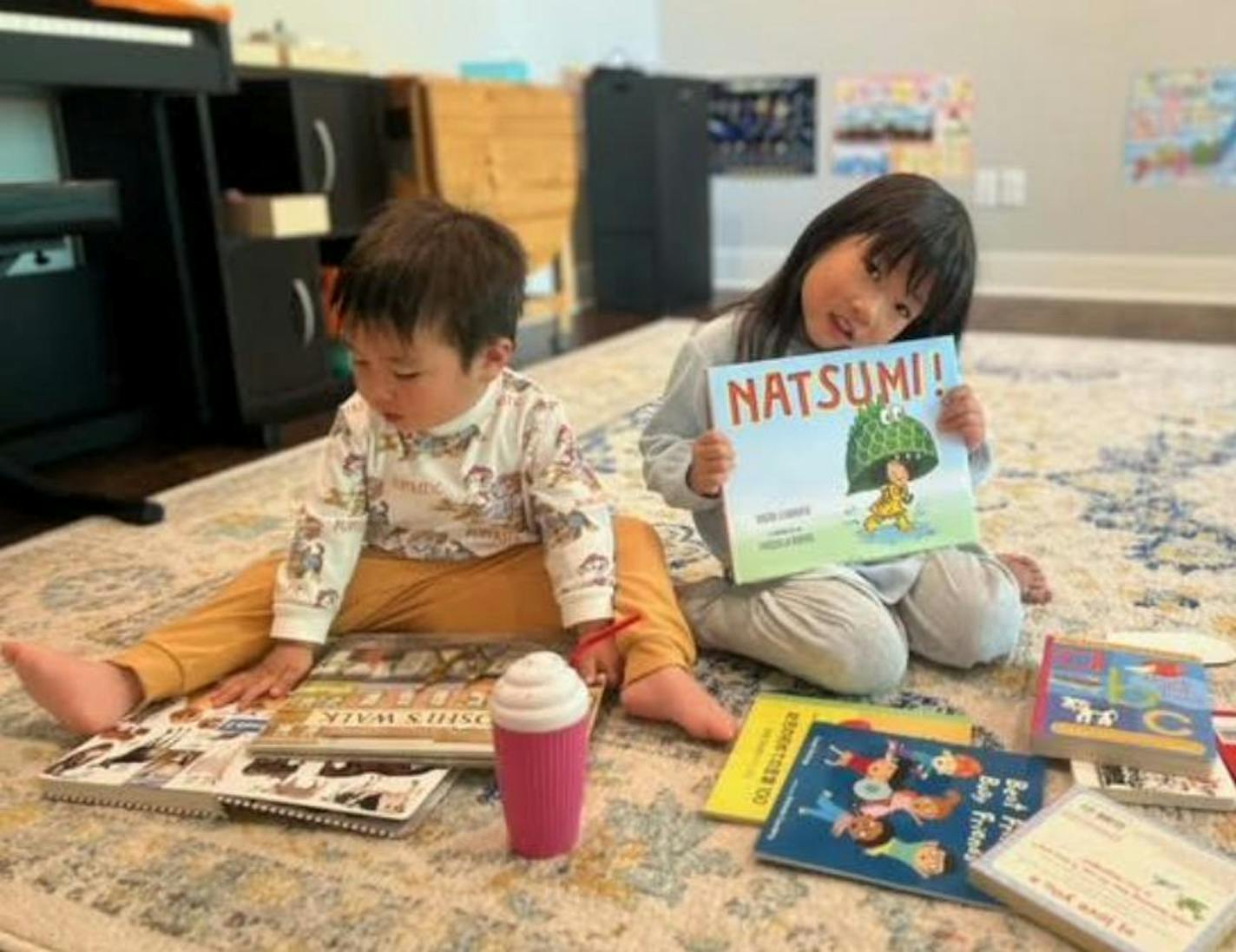 photo of two children with books