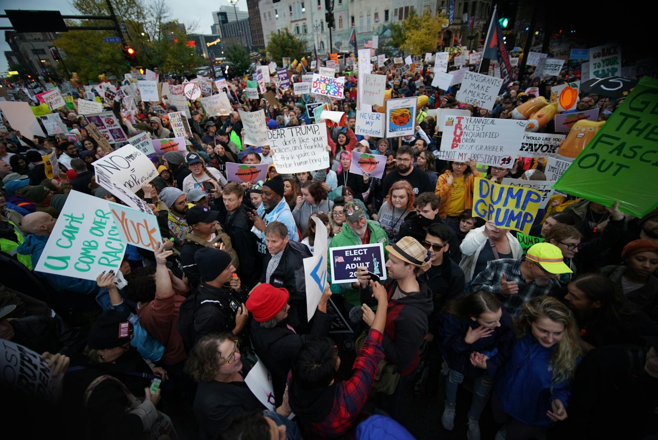 Supporters of and protesters against President Trump interact outside Target Center.