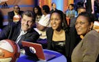 Connecticut's Maya Moore, center, sits with UConn coach Geno Auriemma, left, and her mother, Kathryn Moore, prior to being chosen by the Minnesota Lyn
