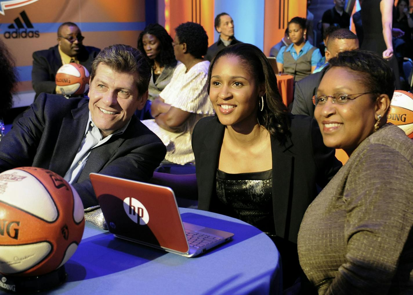 Connecticut's Maya Moore, center, sits with UConn coach Geno Auriemma, left, and her mother, Kathryn Moore, prior to being chosen by the Minnesota Lynx with the No. 1 pick in the WNBA basketball draft in Bristol, Conn., Monday, April 11, 2011. (AP Photo/Jessica Hill)