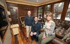 Carl Unger, left, and Nate Tollefson of Craft Design Build with homeowner Caryn Schall in the new year-round room they created in a former three-seaso