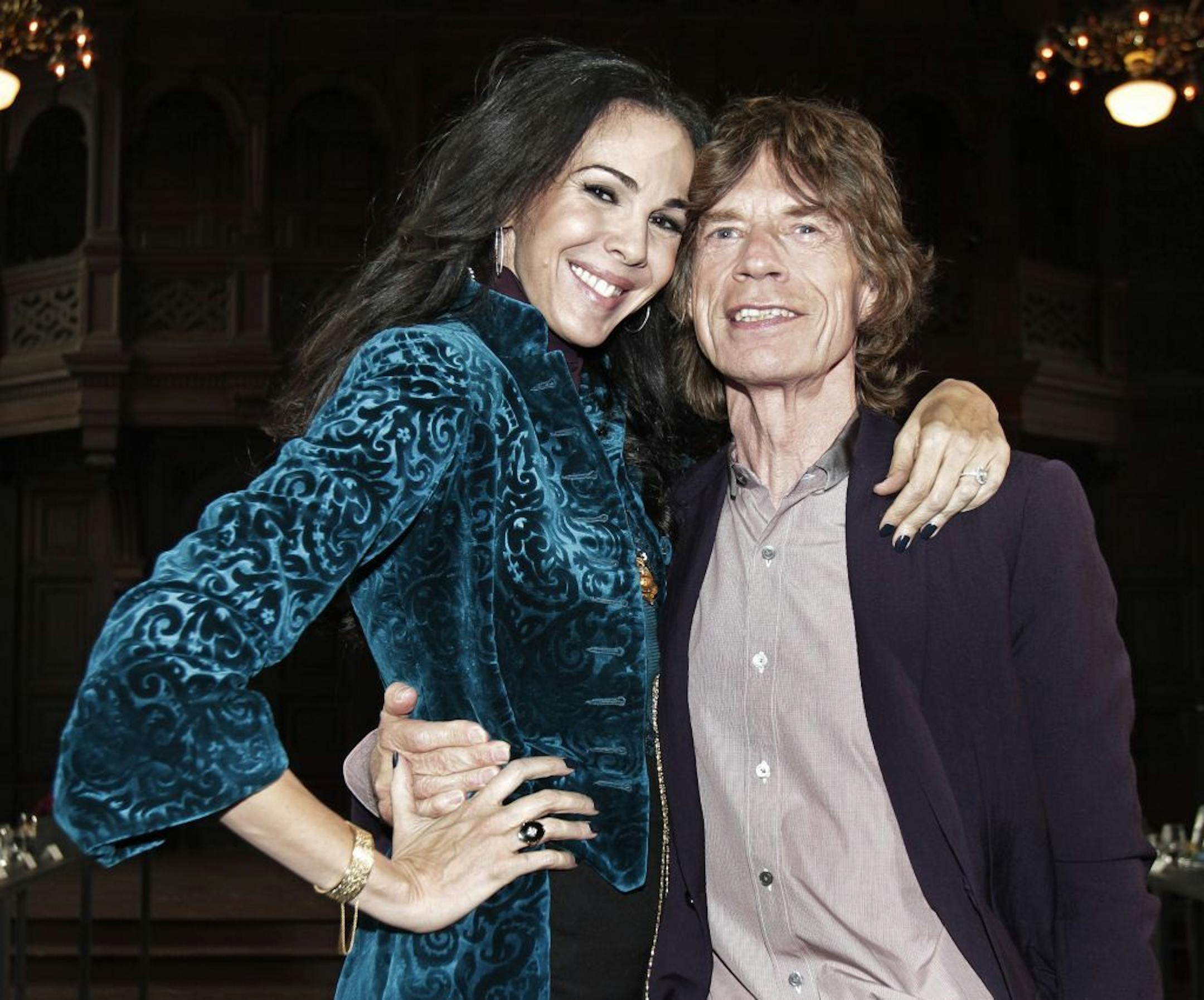 This Feb. 16, 2012 file photo shows singer Mick Jagger, right, with designer L�Wren Scott after her Fall 2012 collection was modeled during Fashion Week, in New York.