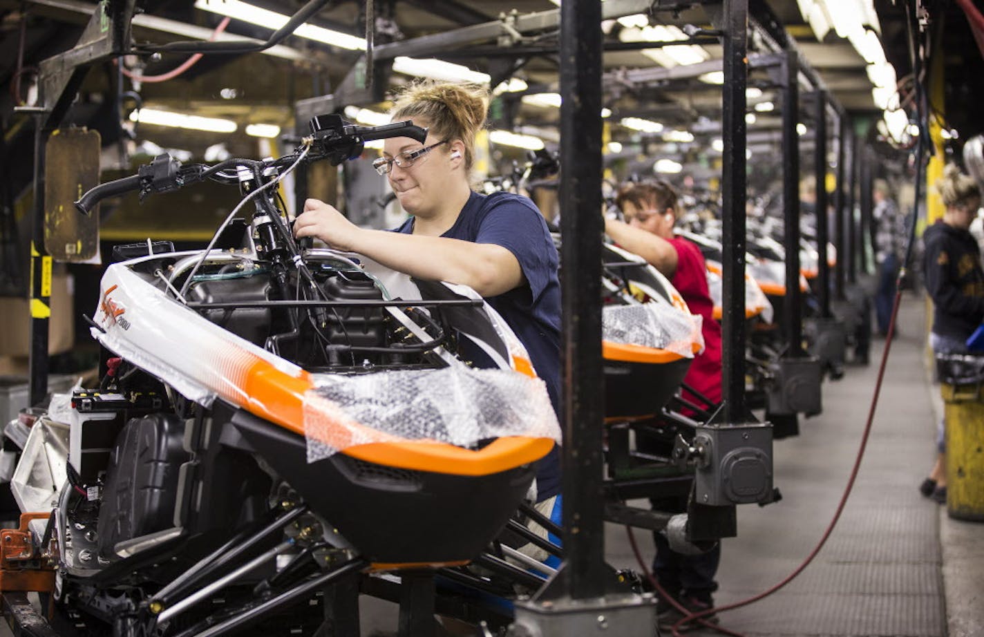 Workers assemble the 2016 Lynx 2000 snowmobile at the Arctic Cat factory in Thief River Falls on Wednesday, September 30, 2015. ] LEILA NAVIDI leila.navidi@startribune.com / BACKGROUND INFORMATION: Arctic Cat management did not allow the photographer to get any names of the workers.