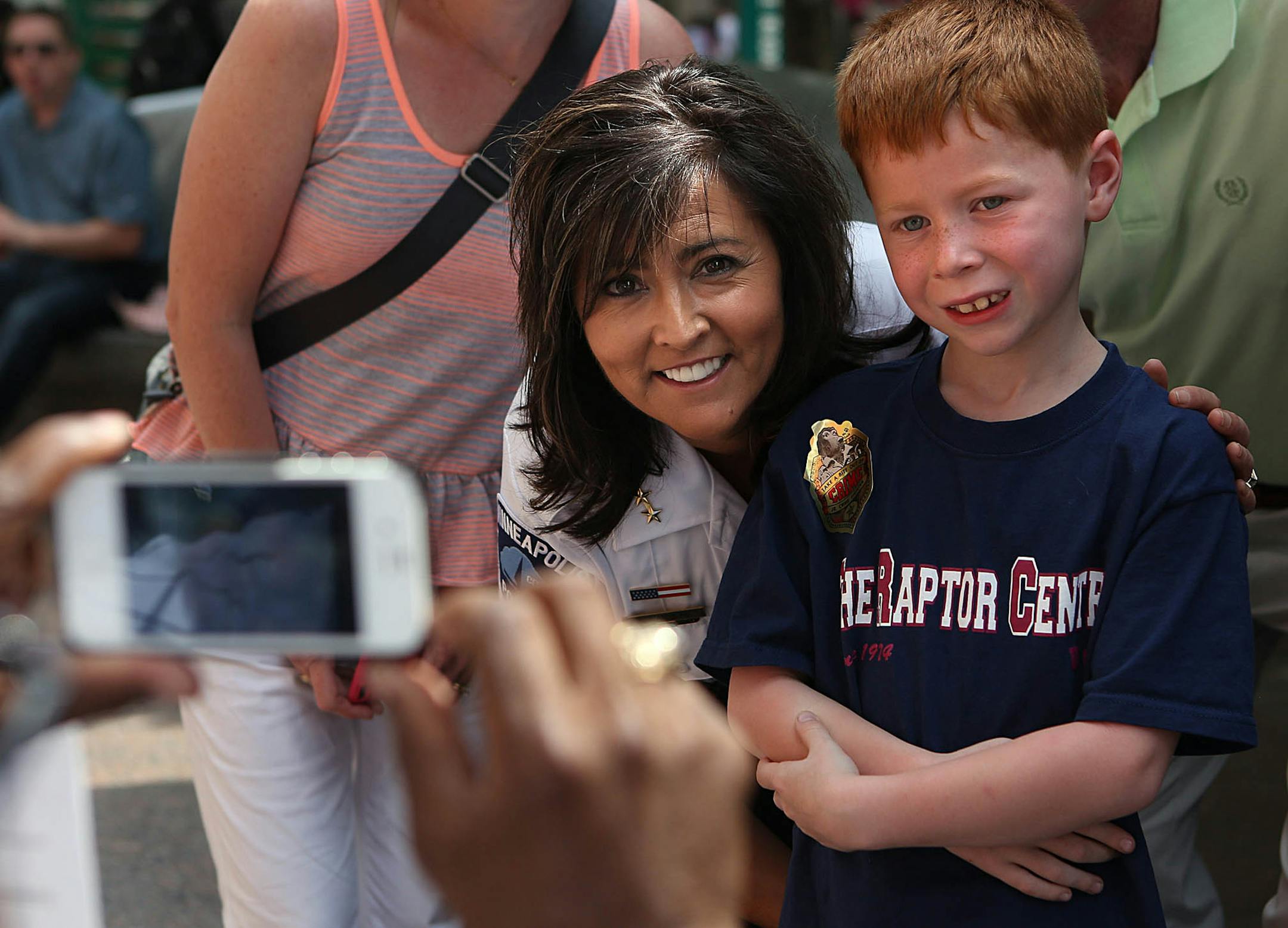 Eight-year-old Ben Mimick, Minneapolis, posed for a photograph with Minneapolis Police Chief Janee Harteau.] (JIM GEHRZ/STAR TRIBUNE) / June 20, 2013, Minneapolis, MN ‚Äì BACKGROUND INFORMATION Minneapolis Police Chief Janee Harteau recently visited Nicollet Mall during a crowded June afternoon in downtown Minneapolis, where she greeted people over the noon-hour and stopped for lunch at a food truck.