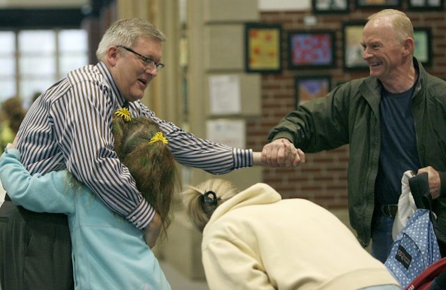 Burroughs Community School Principal Tim Cadotte was greeted with hugs by his students as they made their way to class early Tuesday morning, May 5, 2009, in Minneapolis on Cadotte's first day back to school after a suspension following an altercation with a school board member.