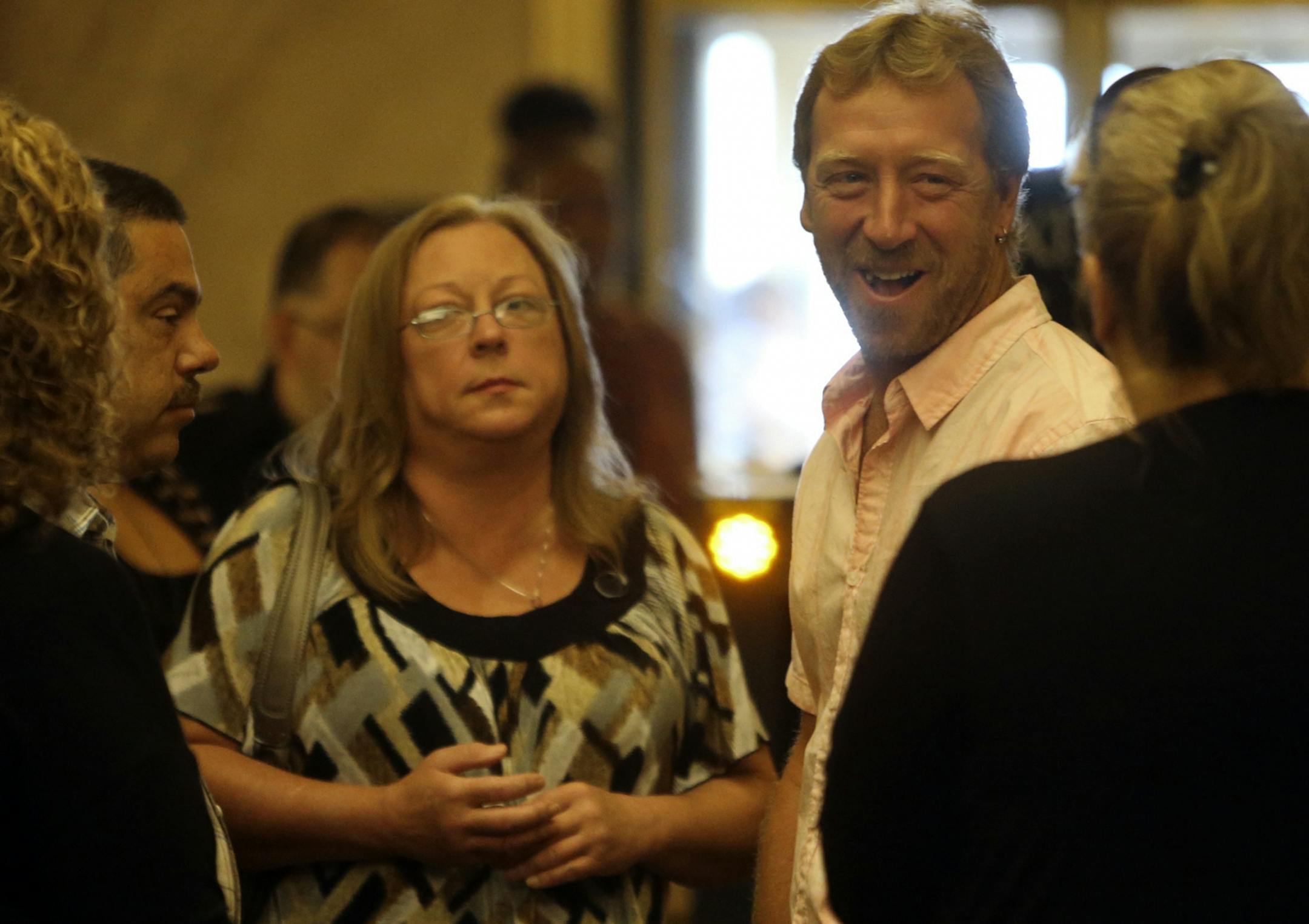 Jay Steger, second from right to left, and Marcie Steger, parents of Kira Steger, wait for an elevator before heading to the courtroom for the start of the murder trial of Jeffrey Trevino, Kira's husband, Thursday, Sept. 19, 2013, at the Ramsey County Courthouse in St. Paul.