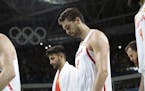 Spain's Ricky Rubio, left, and Pau Gasol (4) walk off the court following their loss to Brazil in a men's basketball game at the 2016 Summer Olympics 