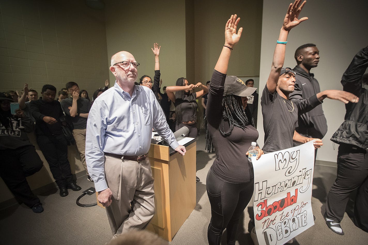 St. Olaf College President David R. Anderson was surrounded by students in the Tomson Hall auditorium who were demanding action and dialogue after a number of incidents of racial harassment happened on campus.